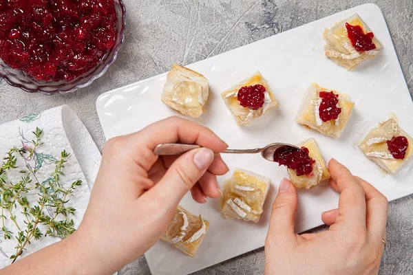 Holiday appetizers with cranberry, brie and thyme — Stock Photo, Image