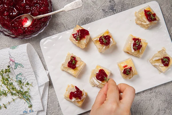 Holiday appetizers with cranberry, brie and thyme — Stock Photo, Image