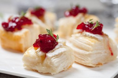 Holiday appetizers with cranberry, brie and thyme clipart