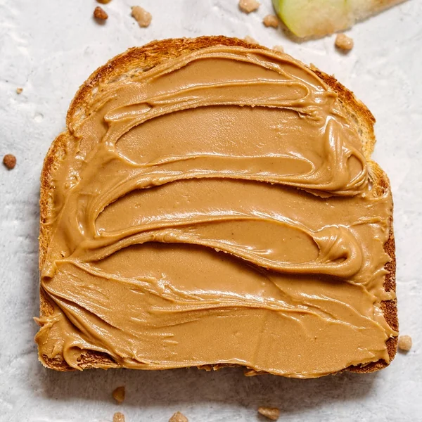 Peanut butter on a slice of Toast. — Stock Photo, Image