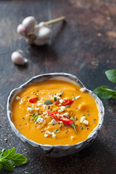 Roasted pumpkin and carrot soup with feta cheese and chili — Stock Image Roasted pumpkin and carrot soup with feta cheese and chili Royalty Free Stock Images
