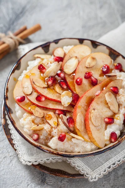 Coconut rice with pomegranate, pear and almond slices — Stock Photo, Image