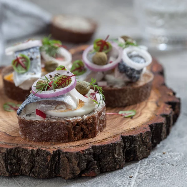 Open sandwich smorrebrod with herring, onion and eggs — Stock Photo, Image
