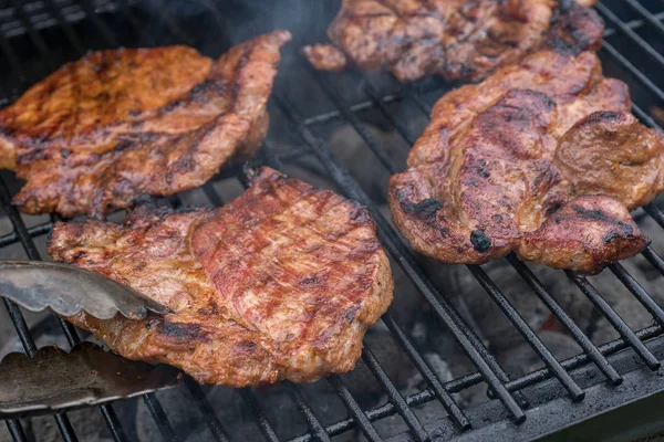 Pork steak meat on bbq grill — Stock Photo, Image