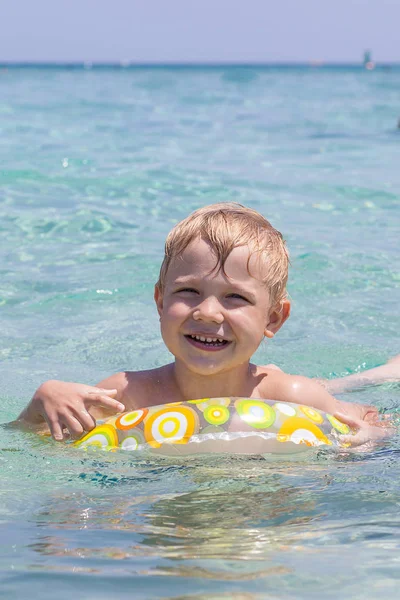 Criança feliz brincando no mar. Conceito de férias de verão — Fotografia de Stock