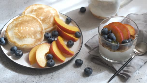 Pfannkuchen mit Pfirsichen, frischen Blaubeeren und Ahornsirup. — Stockvideo