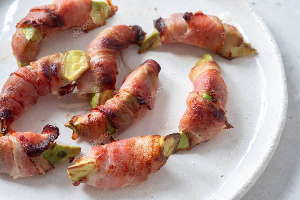 Roasted avocado pieces wrapped in bacon