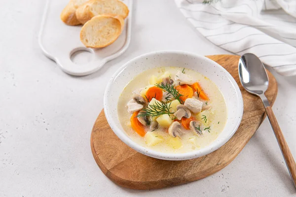 Chicken and potato chowder soup with green dill and carrot in bowl with toasted bread slices on the side. Keto diet — Stock Image Chicken and potato chowder soup with green dill and carrot in bowl with toasted bread slices on the side. Keto diet Royalty Free Stock Images