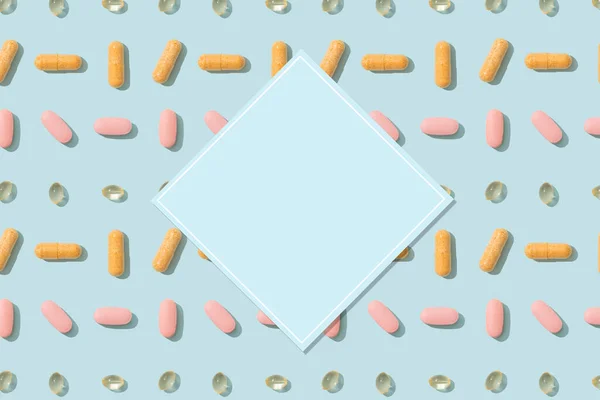 Colorful drugs pattern with copy space for text. Capsule pills and tablets pattern on a blue background with copy space. Cover, pharmacy, drugs, medicine backdrop. Top view