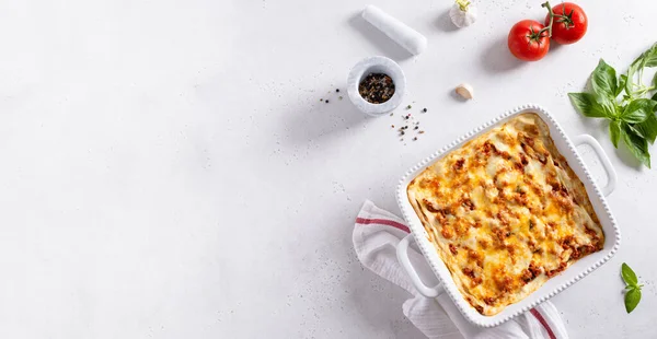Italian restaurant banner. Lasagna with vegetables, minced meat, cheese bolognese and bechamel sauce. Top view, menu, recipe. Copy space for text