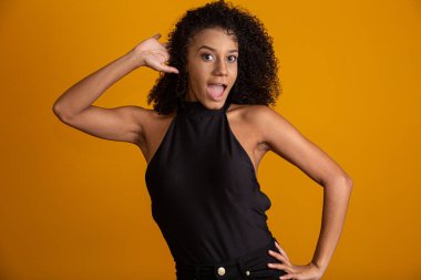 Kıvırcık saçlı, kameraya bakıp gülümseyen genç Afro-Amerikalı kadın. Kıvırcık saçlı, kameraya bakıp gülümseyen tatlı afro kız..