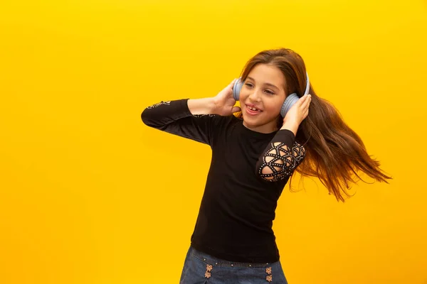 Girl enjoying music wearing headset and dancing