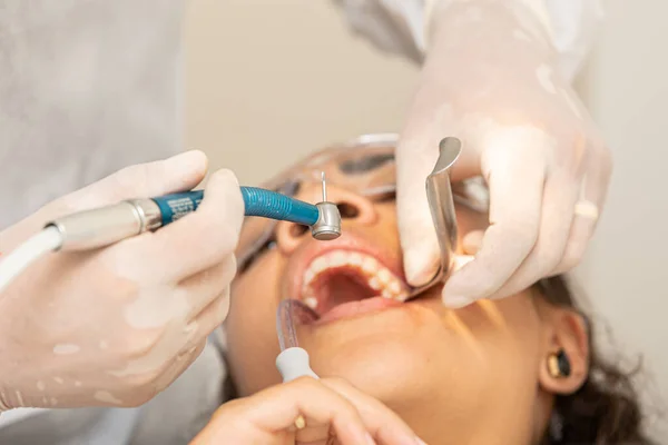 Young woman being seen in a dentist\'s office. Concept of toothache, wisdom tooth extraction, anesthesia, problems with caries or gums. Oral health care. Dentist day.