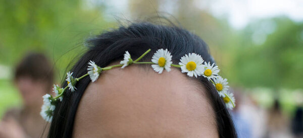 close view of girl in wreath of flowers