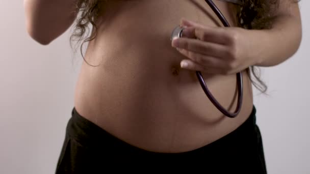 Pregnant Woman Examining Belly Stethoscope — Stock Video