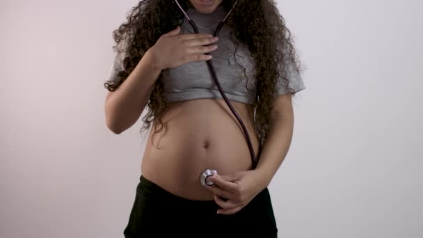 Pregnant Woman Examining Belly Stethoscope — Stock Video