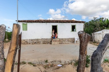 BAHIA, BRAZIL - CIRCA MAY, 2019: Children at the door of their homes in a Quilombola community  clipart