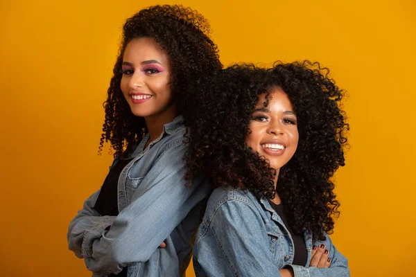 Two beautiful afro friends hugged, concept of best friends and sisters.