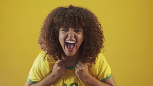 Genç Brezilyalı Kıvırcık Kadın Sarı Arka Planda Hareketli Poz Veriyor — Stok video