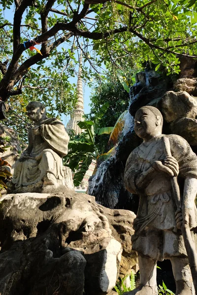 Ancient stone sculptures in the garden of a Buddhist monastery.