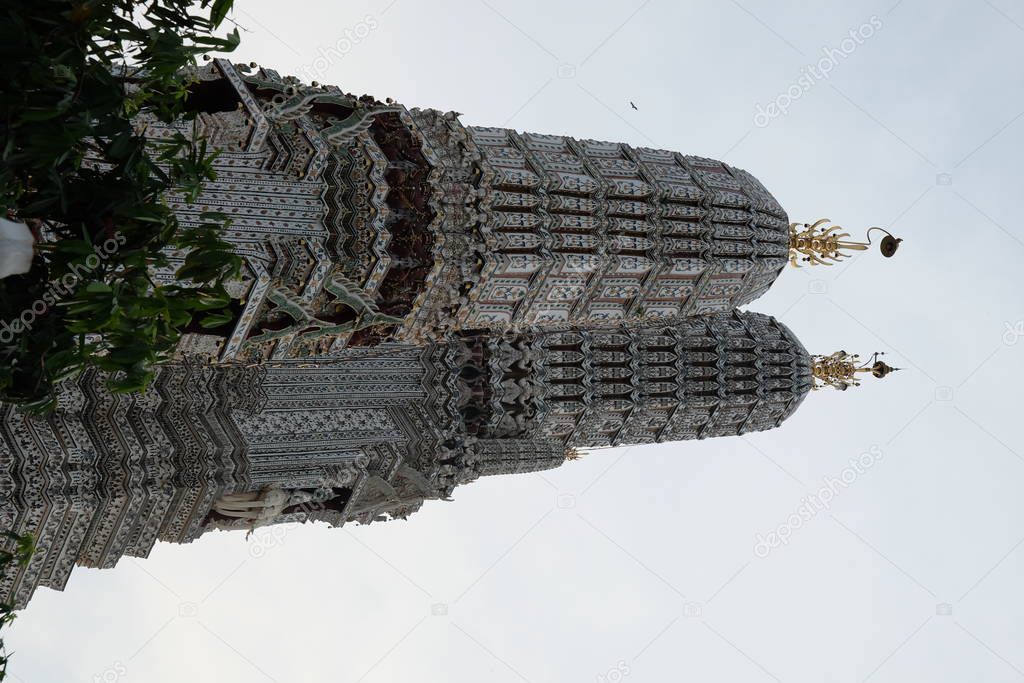 The towers of the Buddhist temple Wat Arun against the evening sky in Bangkok.