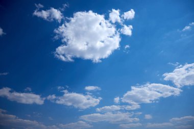 White soft clouds on a blue sky on a sunny day.