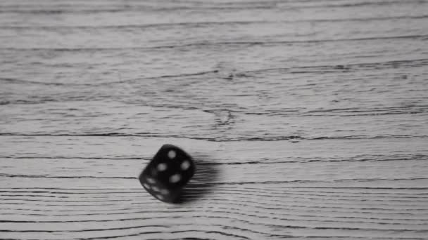 Black Dice Rolls Spins White Textured Wooden Old Table Stops — Stock Video