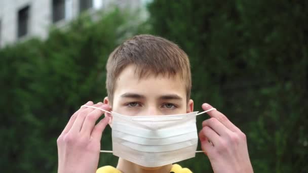 Sad Young Man Teenager Puts Protective Medical Blue Mask Background — Stock Video