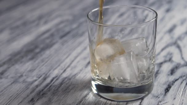 Golden Whiskey Poured Glass Cup Ice Cubes Old Wooden Gray — Stock Video