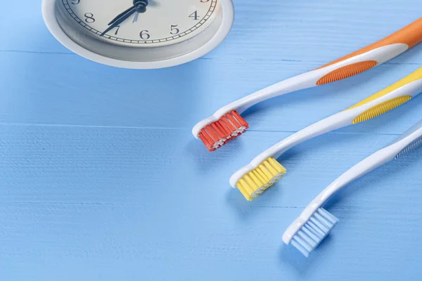 Three Bright Toothbrushes Light Blue Background Orange Yellow Analog Classic — Stock Photo, Image
