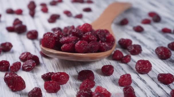 Arándanos Rojos Secos Una Cuchara Madera Espolvoreado Sobre Una Mesa — Vídeos de Stock