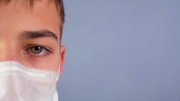 Adolescente Triste Uma Máscara Facial Médica Olha Com Olhos Sombrios — Vídeo de Stock