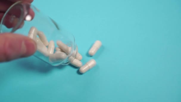 Pharmacist Pours White Medical Capsules Glass Bottle Blue Bright Table — Stock Video