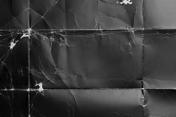 Kırışık ve ovulmuş köşeli buruşuk siyah kağıt. Eski paket tozlu karton. Soyut dramatik arka plan. Tasarım ve başlıklar için.