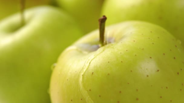 緑色の熟したリンゴが洗浄されます 滴と純粋な水の流れが落ちる 接近中だ マクロショット スローモーション 調理や食事の前に果物の食事や果物洗浄 — ストック動画