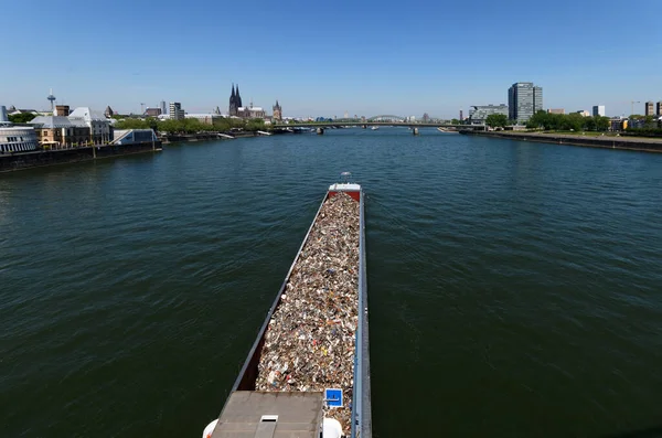 cargo ship with scrap metal under the severins bridge on the rhine in cologne