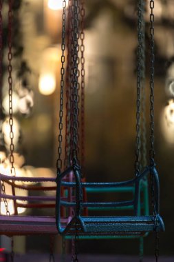 Gece şehrin arka plan ışıkları boş ıslak salıncak