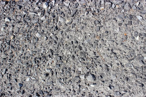 Crushed old asphalt pavement. Small gray-black pebbles. — Stock Photo, Image