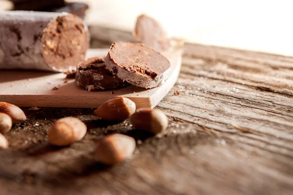 Cuts of chocolate sausage with hazelnuts — Stock Photo, Image