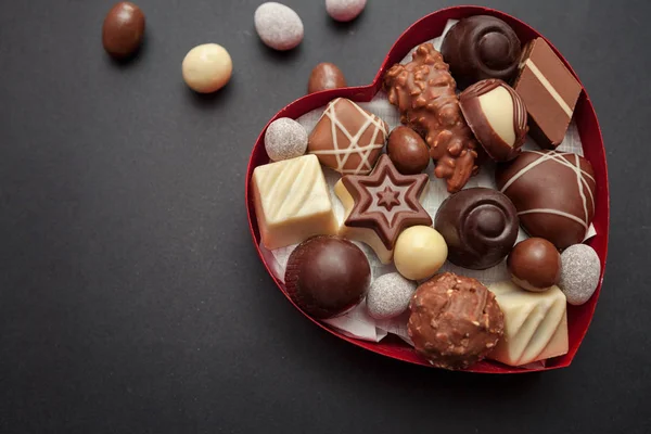 Chocolate pralines in red heart shape box — Stock Photo, Image