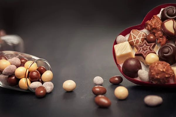 Heart shaped box and glass with chocolate truffles for Valentine — Stock Photo, Image