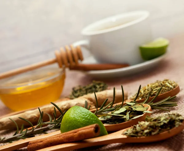 Spoons with tea herbs, lime and honey