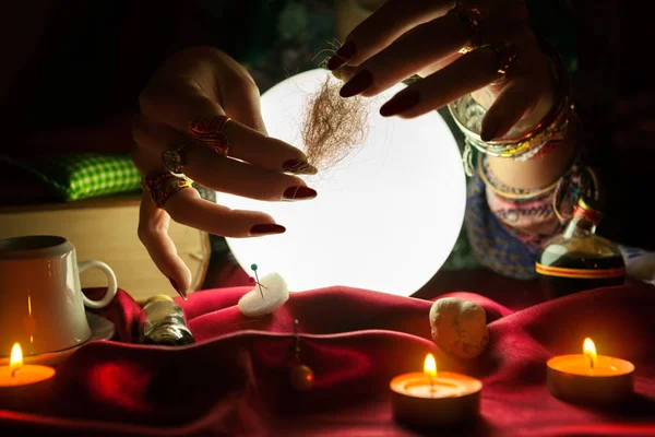 Çingene falcı saç demeti onun elinde tutan