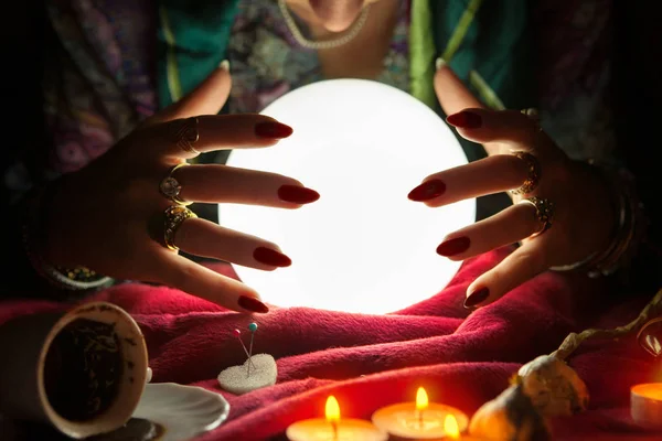 Hands of an female fortune teller around a crystal ball — Stock Photo, Image