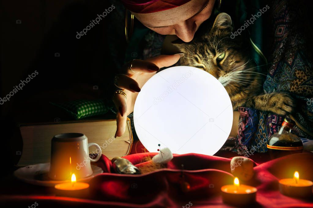 Gypsy woman fortune teller holding cat in her arms