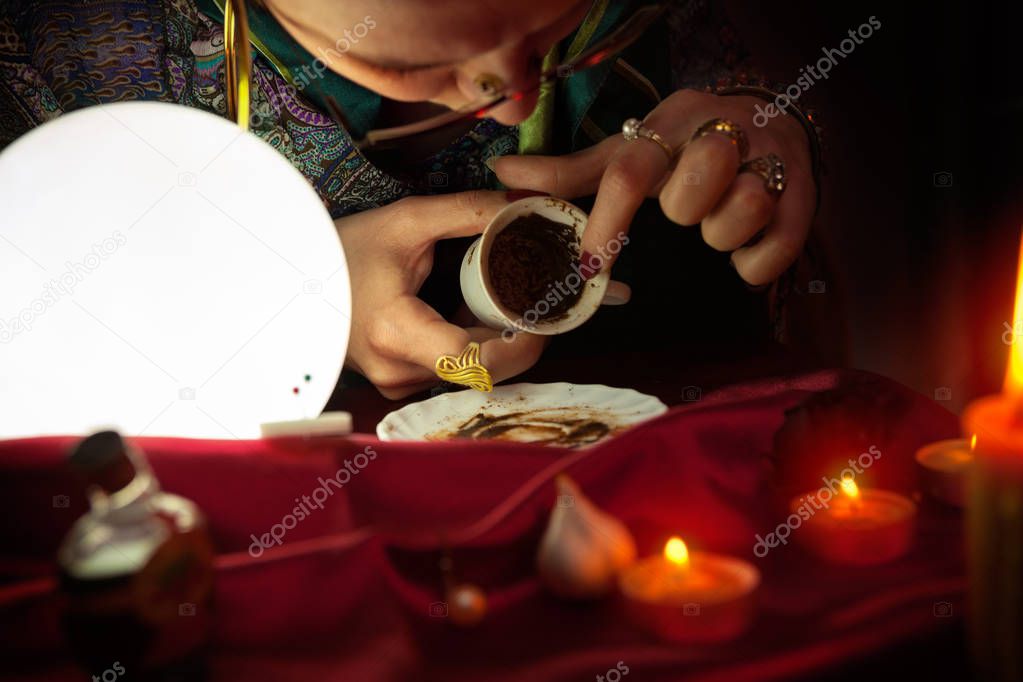 Fortune teller reading fortune from an empty coffee cup