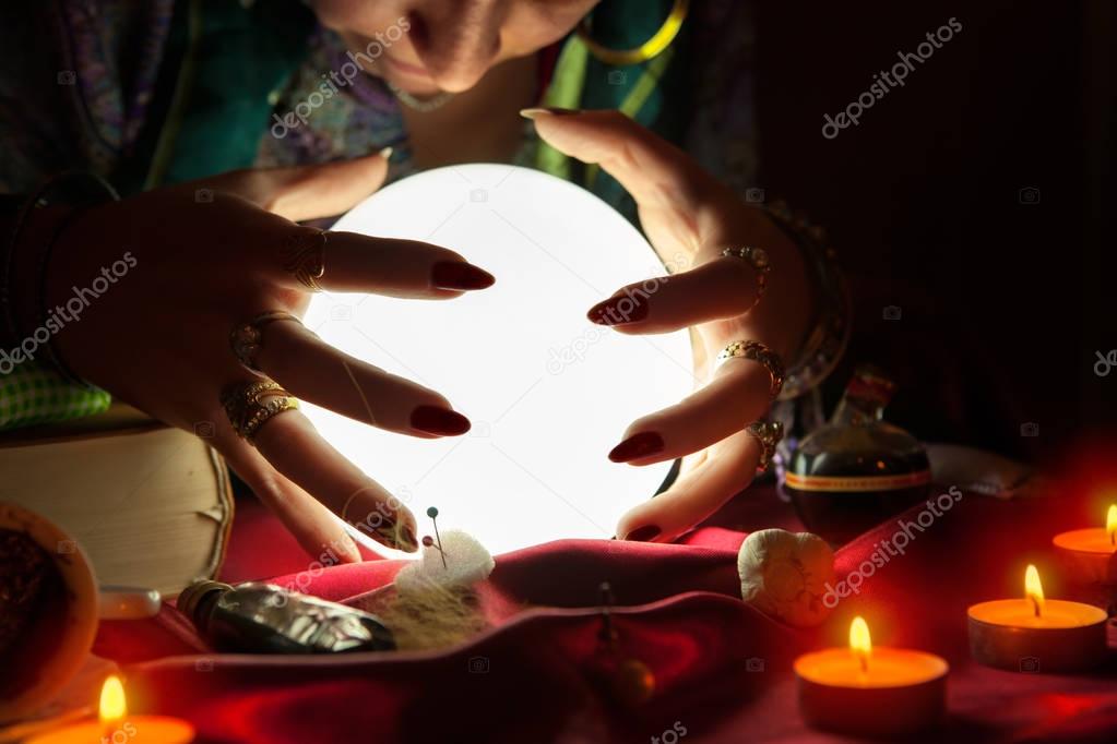 Gypsy fortune teller with crystal ball predicting the future