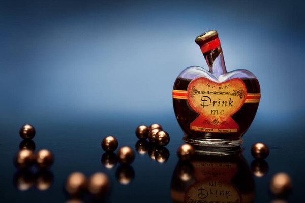 Heart shaped bottle with romantic potion with heart shaped liquid