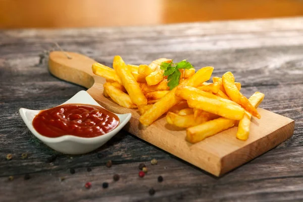 Sirve papas fritas en la tabla de cortar — Foto de Stock