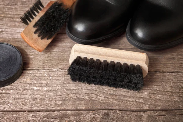 Cleaning brushes, black boots and polish cream